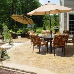 Stamped Concrete Patio with a Paver Wall