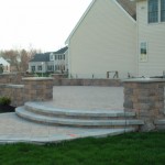 Raised Paver Patio with Outdoor Kitchen, Retaining Wall, & Columns